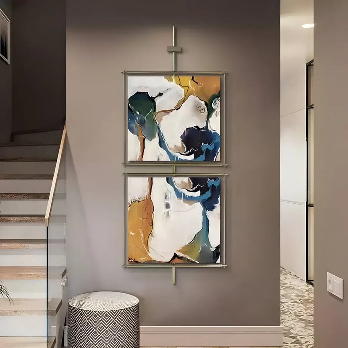 A stylish hallway with two vertically framed abstract paintings in deep blue and gold tones, enhancing the contemporary aesthetic.