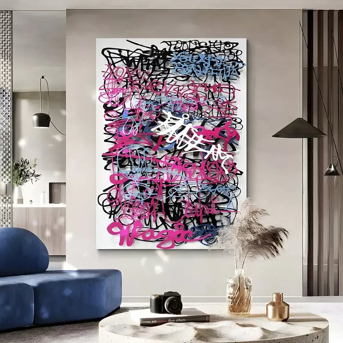 A contemporary interior with a vibrant graffiti-style wall art piece featuring layered pink, black, and blue calligraphy, enhancing the modern aesthetic.