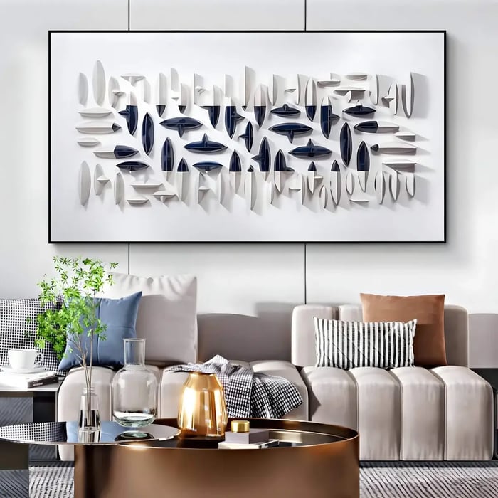 A contemporary living room with a large framed geometric art on the wall in white and navy, featuring layered geometric elements that add texture and depth.