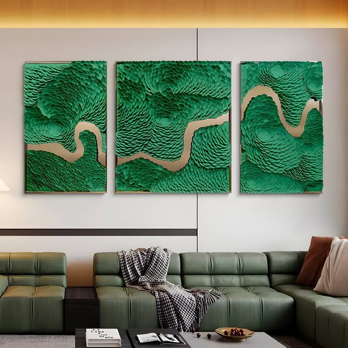 Green textured triptych wall art with gold accents above a luxurious olive leather sectional.