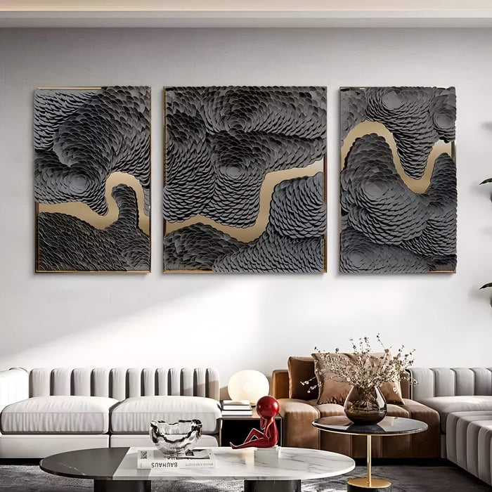 Sophisticated living room with three-panel leather art featuring textured black waves and golden rivers.