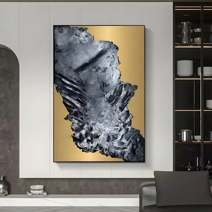A luxurious setting showcasing a large abstract wall art piece with textured black elements against a gold background, adding a bold visual contrast.