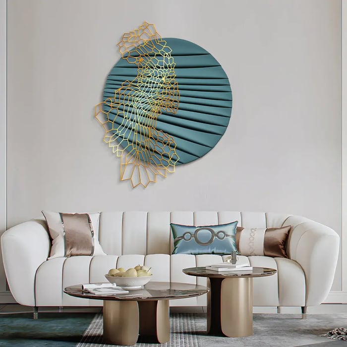 A sophisticated living room featuring a teal and gold circular wall sculpture with intricate metal lattice details, adding a modern artistic touch above a white tufted sofa.
