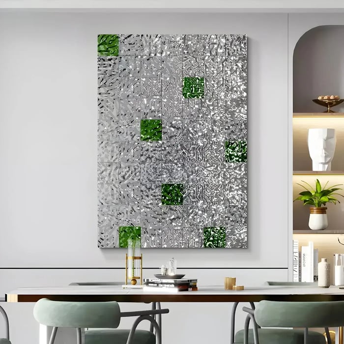 Silver and green textured wall art in a contemporary dining space – A large silver artwork with green geometric accents above a modern dining table.