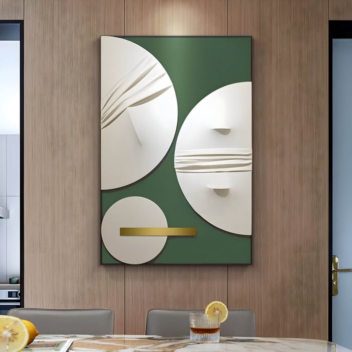 Modern wall art with abstract white and gold circular forms on a green background, dining setup below.