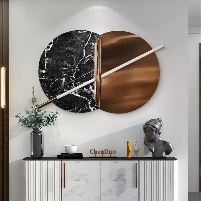 A modern space featuring a striking circular wall sculpture combining black marble, copper, and a sleek white LED accent, adding elegance to the decor.