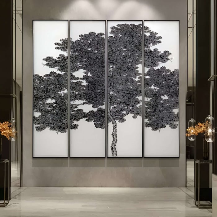 Large four-panel monochrome tree artwork displayed prominently in a modern lobby.