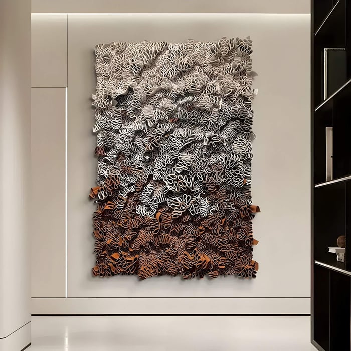 Liora Brown Ombre Ribbon Leather 3D Wall Art hanging on a modern interior hallway, showcasing layered leather ribbons in gradient brown, white, and black tones with sculptural depth.