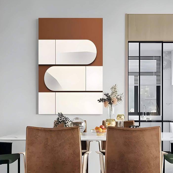 Rectangular 3D wall art featuring staggered white leather panels with curved edges over a warm brown backdrop, displayed in a contemporary dining area with earthy tones and modern décor.