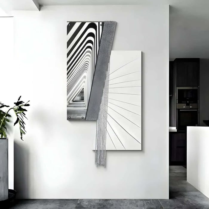 Minimal white wall displaying two overlapping black-and-white architectural abstract canvases, one with bold striped lines and textured draped detail.