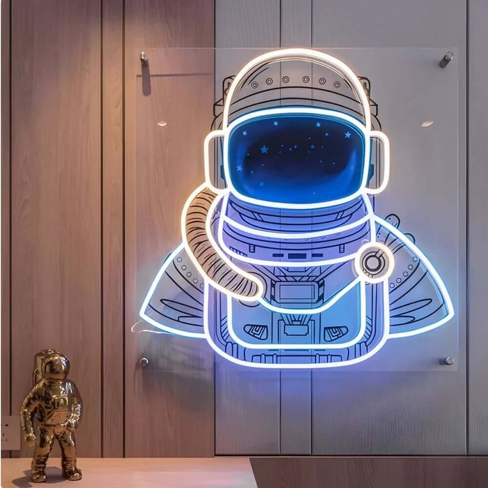 Glowing astronaut LED neon wall light in a space-themed kids room art.