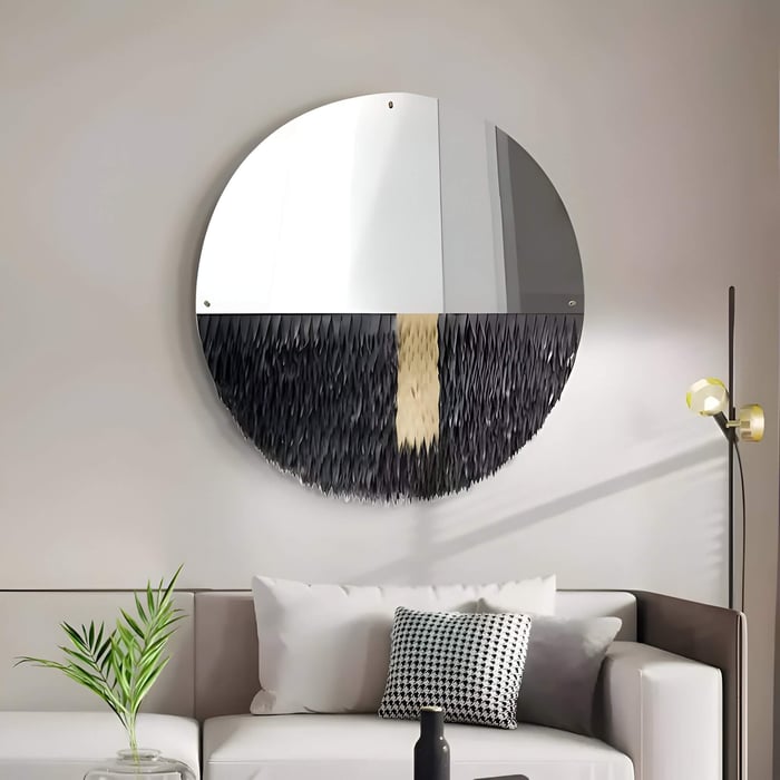 Round mirror and black leather wall art combo with textured lower half in a stylish lounge.