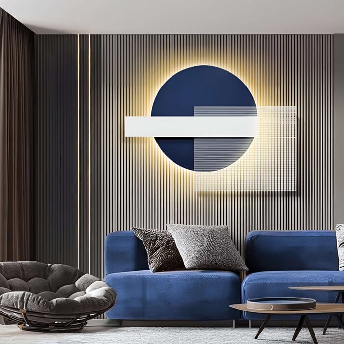 Modern lounge with illuminated blue and white geometric wall decor against textured paneling.