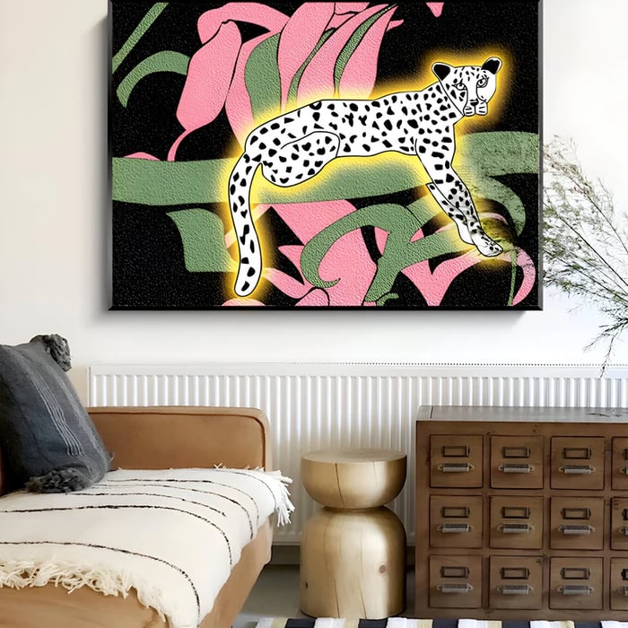 A bold wall art piece featuring a glowing spotted cheetah surrounded by oversized botanical elements in pink and green, enhancing a modern, nature-inspired setting.