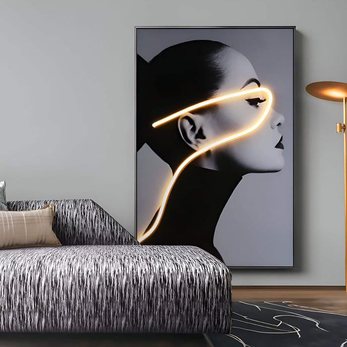 Striking neon portrait of a woman with glowing orange light line across her face in a chic gray lounge.
