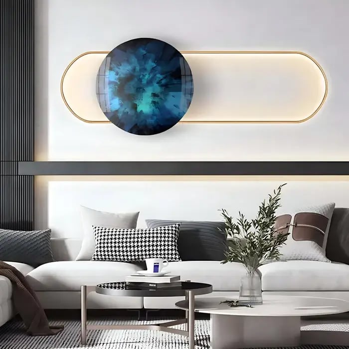 A stylish interior featuring a circular blue wall art with an elongated oval light accent, adding a contemporary touch to the modern sofa setup.