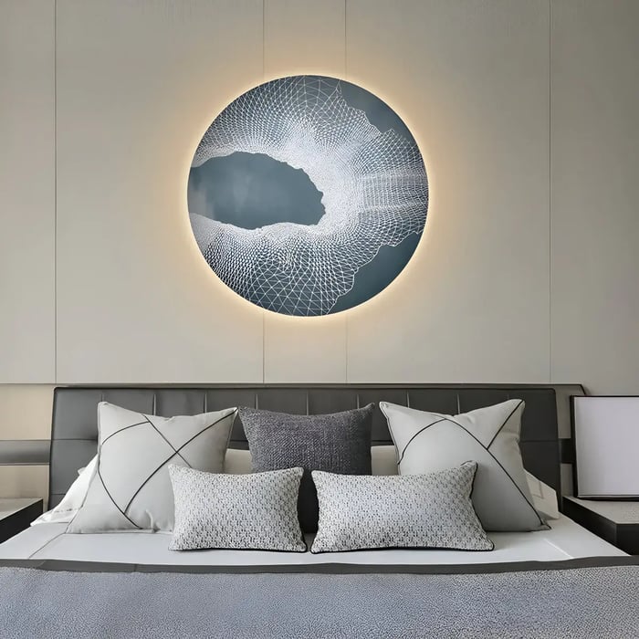 A stylish bedroom showcasing a round illuminated artwork with a deep blue and white geometric mesh design, creating a dynamic focal point above the bed.
