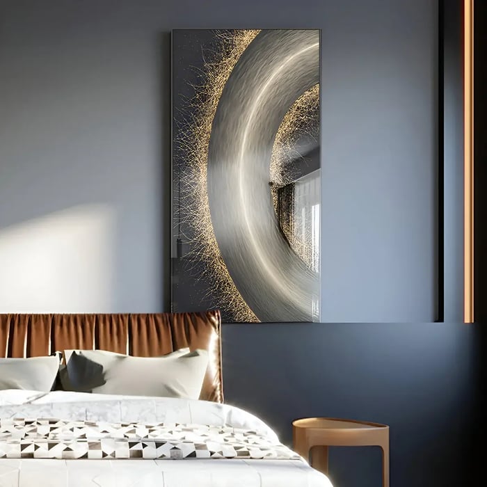 A sophisticated bedroom with a striking vertical artwork featuring a metallic circular swirl design with gold and silver accents, set against a dark navy wall.