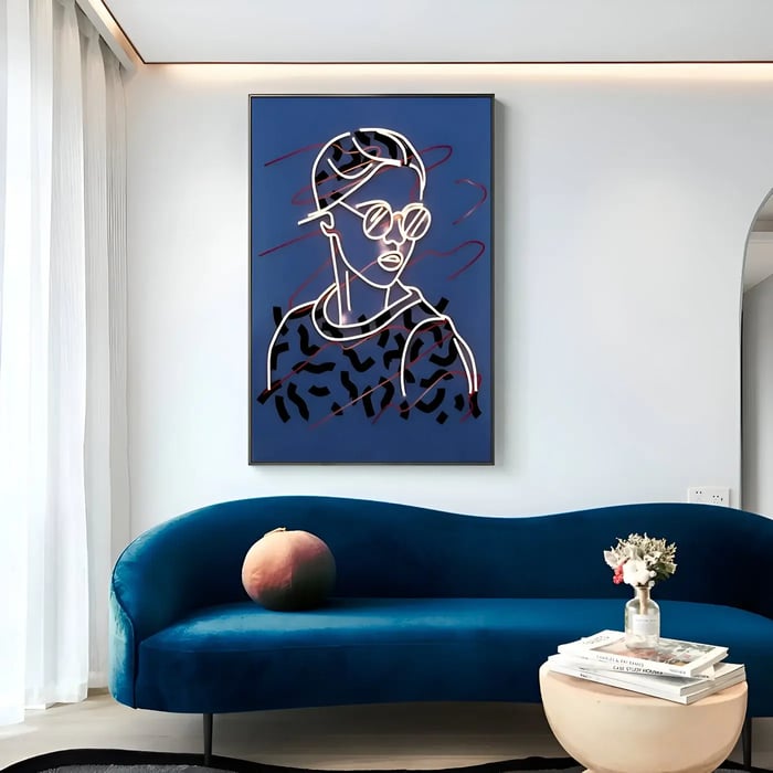 Neon portrait artwork in a modern lounge area – A large blue-framed neon line drawing of a woman displayed above a velvet blue curved sofa.