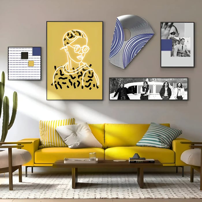 A lively living space with a yellow sofa and an eclectic gallery wall featuring a neon-outlined portrait, abstract geometric pieces, and black-and-white photography.