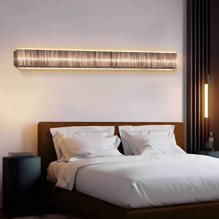 Long rectangular LED-lit wall piece above a modern bed, featuring subtle linear woodgrain textures in neutral tones, enhancing a calming atmosphere.
