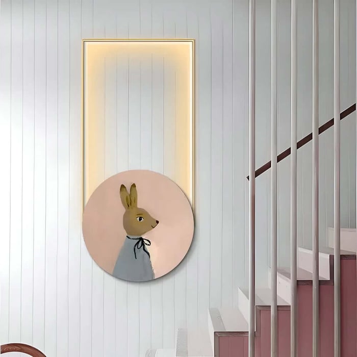 Stairwell with white vertical paneling and a glowing rectangular wall niche, accented by a round canvas of a gentle rabbit in profile on a soft pink background.