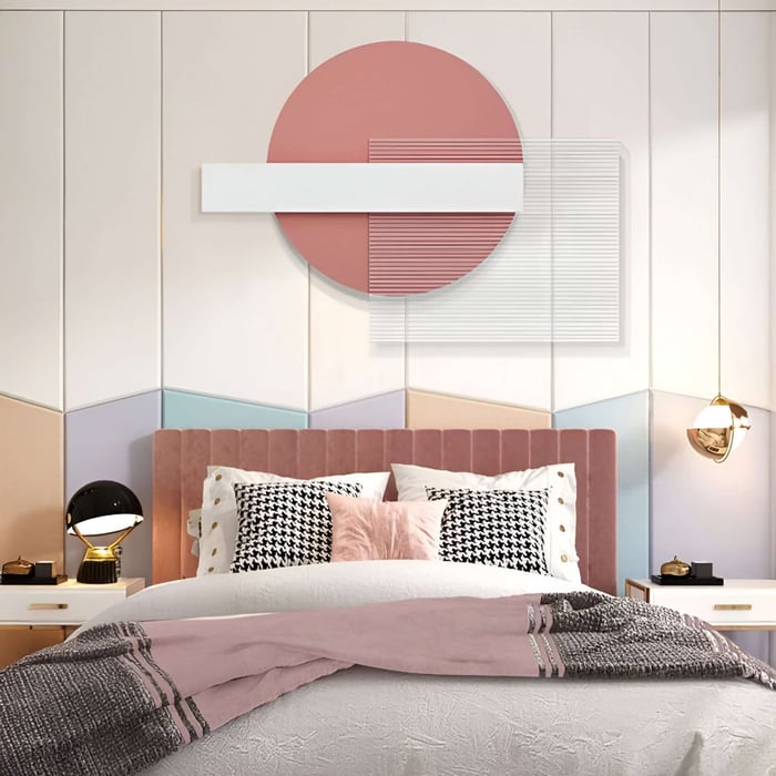 Abstract geometric wall art in blush and white tones above a pink velvet headboard in a pastel bedroom.