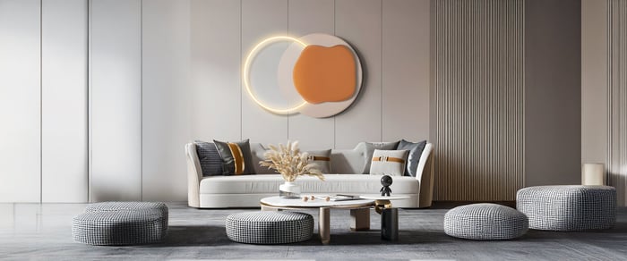 Minimal living room with abstract circular wall wood art, neutral sofa, and round grey poufs.