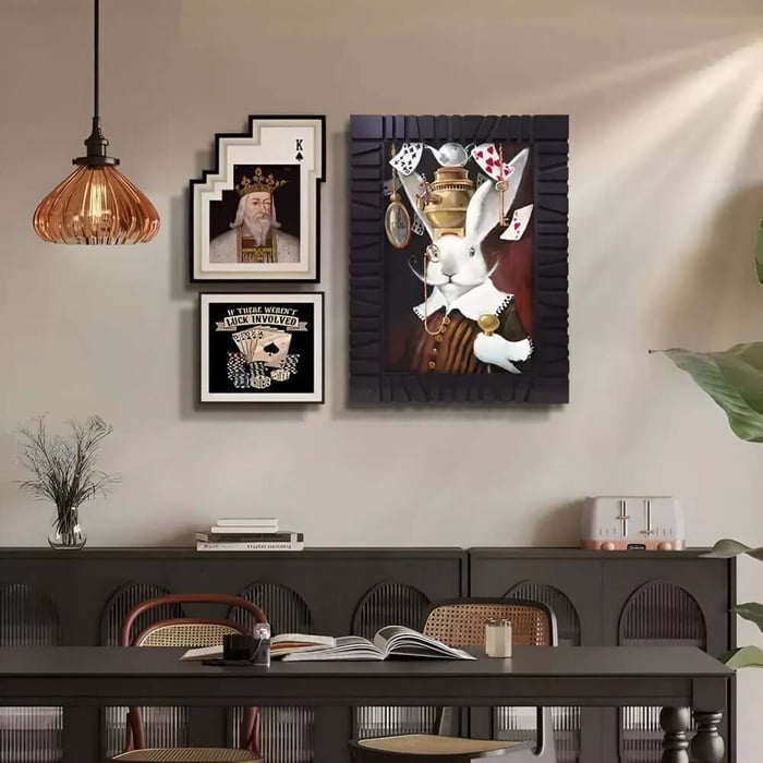 Eclectic dining room wall featuring bold rabbit painting and framed prints.