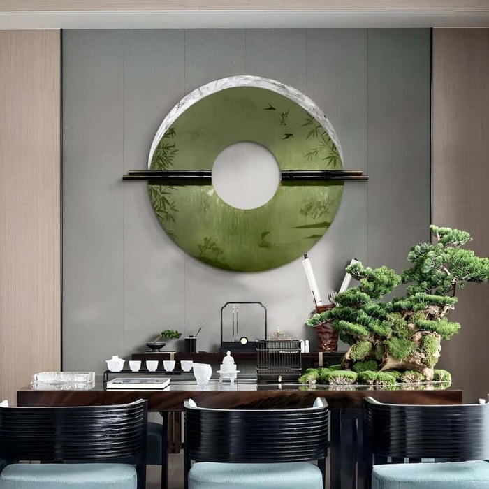 Green circular dining room art above sideboard with bonsai display