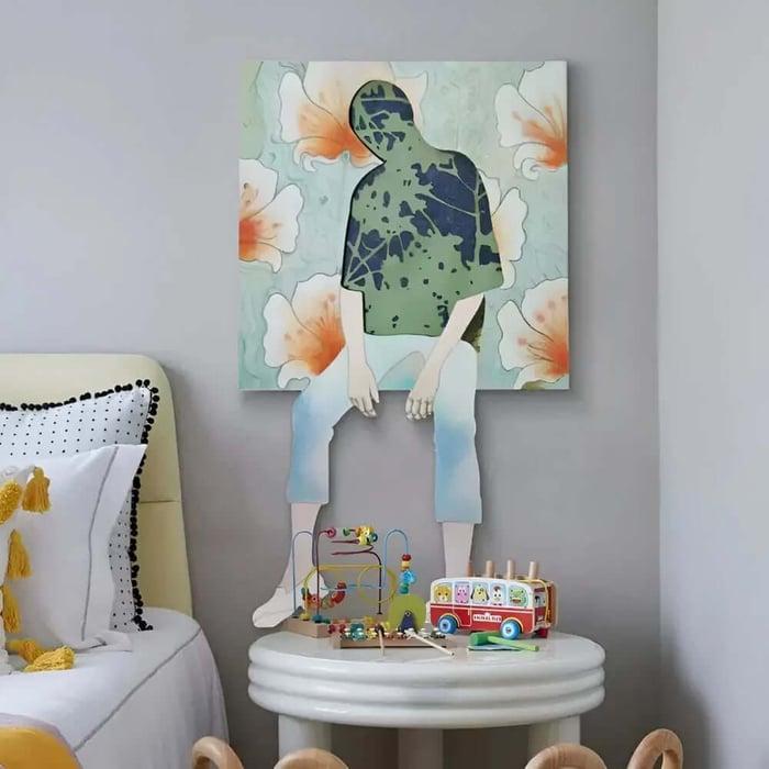 Whimsical figure wall art of a seated child silhouette on floral canvas above a play table in a kids room.