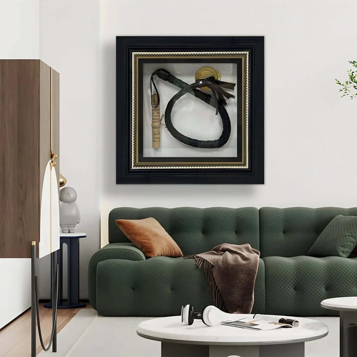 Framed shadow-box wall art above a green sofa in a contemporary living room setting.