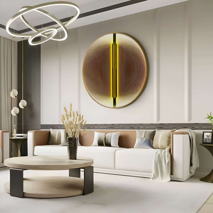 A chic living room with a circular gold and brown wall art installation, highlighted by soft-toned furnishings and a statement lighting fixture.