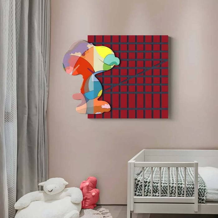 Colourful abstract face artwork on red grid canvas hung above a toddler bed in a modern nursery.