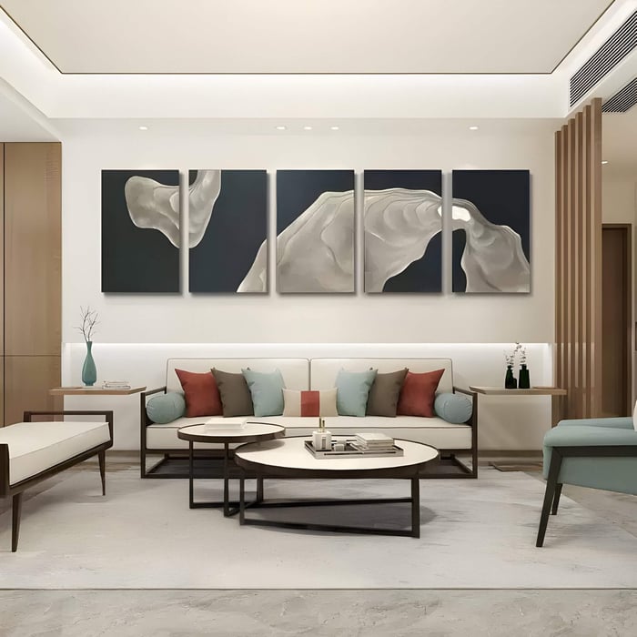 Five-panel sandstone wall art with carved flowing textures in neutral tones, arranged against dark backdrops, creating a striking modern focal point for contemporary interiors.