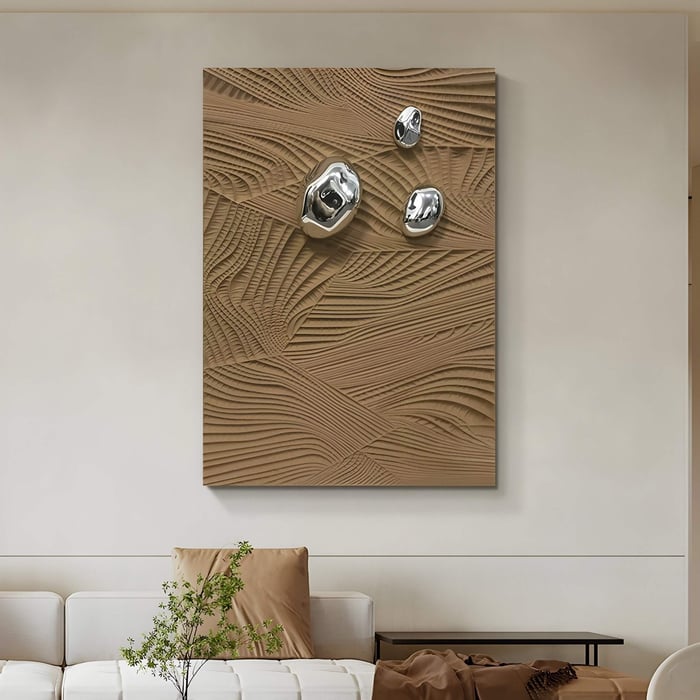 In the modern living room, the Verdara Taupe Wood Relief 3D Wall Art by Giant Sculptures features sculptural details with metallic spheres on a beige-patterned background. A white sofa with brown and beige cushions and a small potted plant complements the contemporary setting.