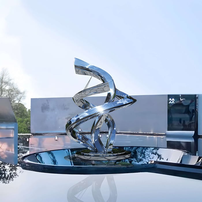 Twist Silver Abstract Outdoor Steel Sculpture placed near water feature in open space