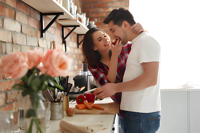 a young couple cooking in a kitchen