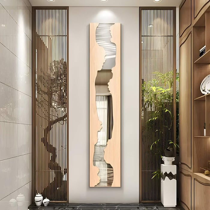 Modern hallway with tall vertical wood and mirror wall sculpture framed by wooden slats and ceramic vases.