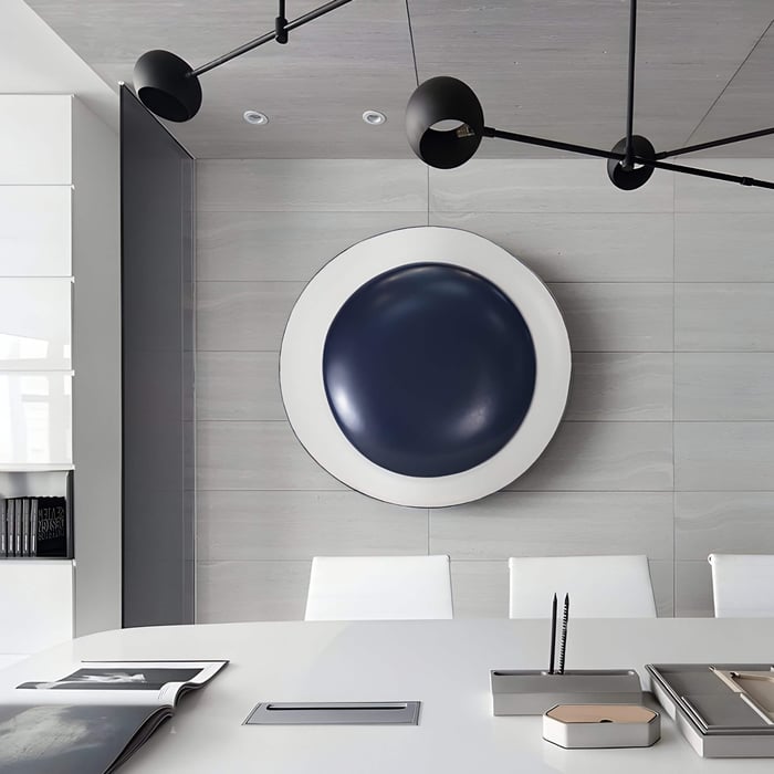 Layered Circular Wall Sculpture – Three-tiered modern circle wall pieces in blue, green, & terracotta on a grey wall.