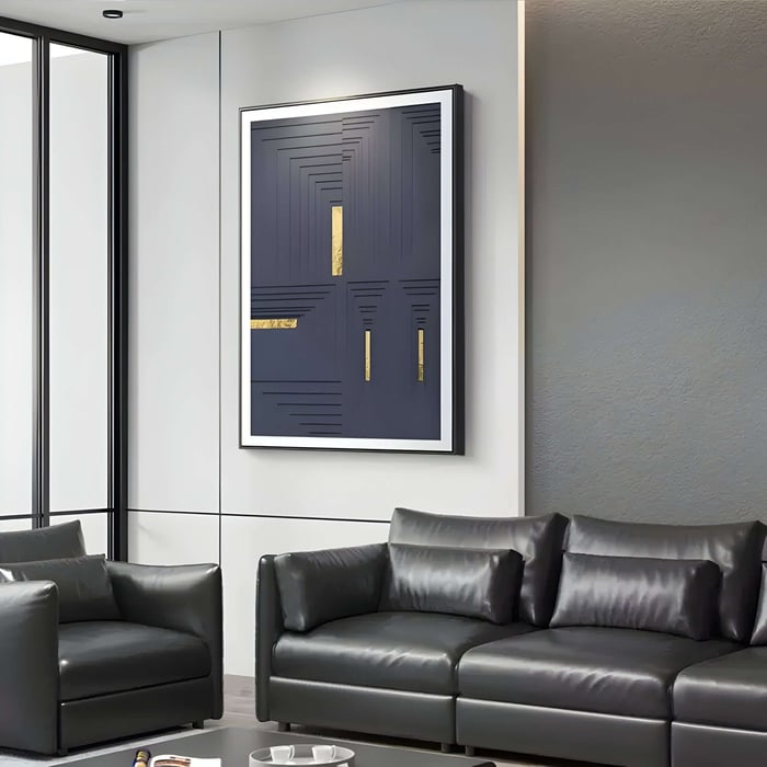 A modern living room features a dark leather couch and armchair with Giant Sculptures Striato Midnight Blue 3D Wooden Wall Art With Gold Accent.