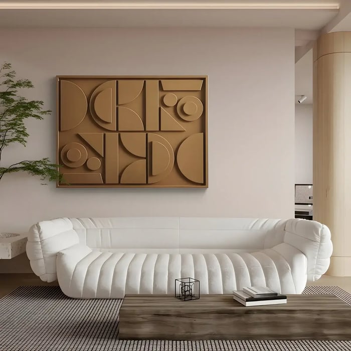 A geometric, textured wall art piece in warm golden tones, featuring bold circular and angular shapes, displayed above a contemporary white sofa with plush, curved seating in a modern living room with wooden furniture and subtle décor elements. This piece serves as striking living room art.