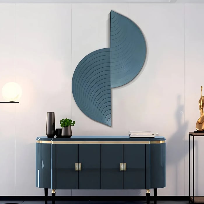 A minimalist and elegant wooden wall installation featuring curved, layered designs in deep blue, paired with a sleek console table in a modern space.