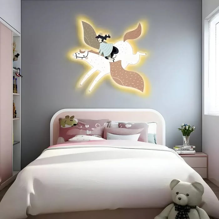 A cozy kids' bedroom featuring a soft pink and grey color scheme, with an illuminated wall art piece of a girl riding a winged horse, emitting a warm glow.