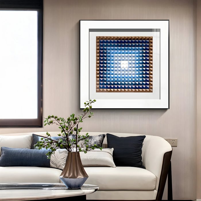 A sophisticated framed wood art with a gradient of blue 3D pyramid-like shapes, creating depth and symmetry in a neutral-toned interior.