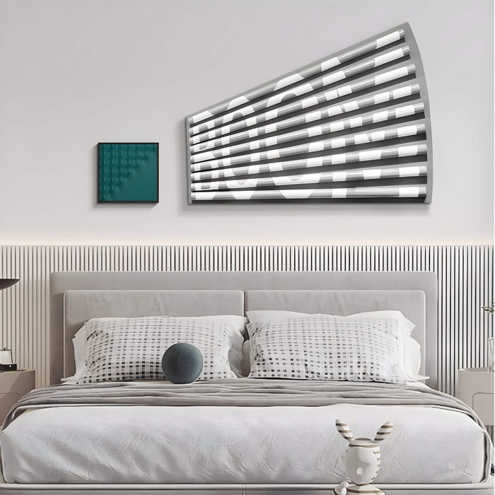 Minimalist bedroom with optical illusion wall art spelling "BOOM" in black and white 3D panels.
