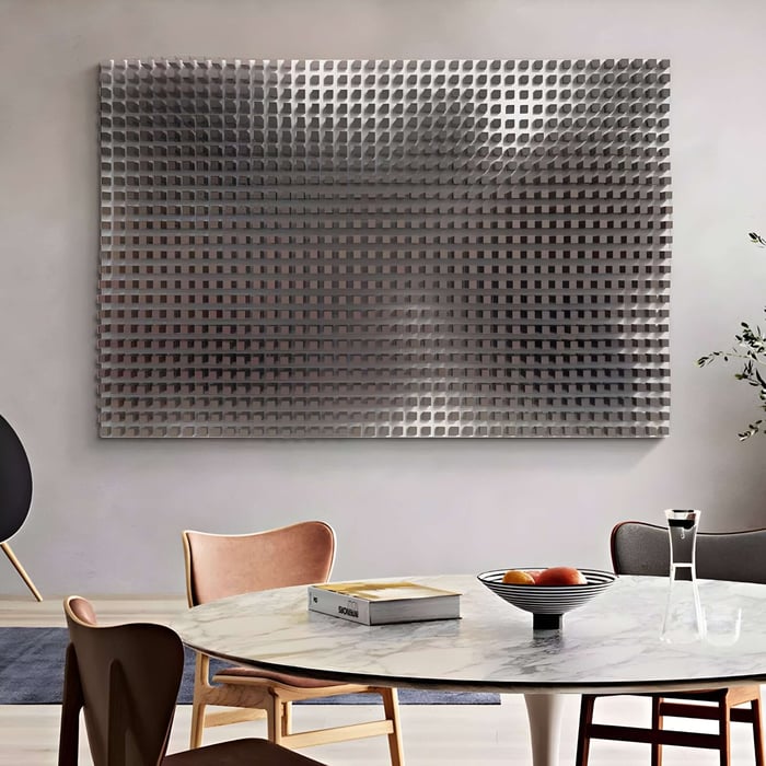 Dining area with metallic 3D grid wall art, marble table, and wooden chairs.
