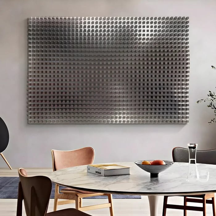 A sophisticated dining space with a large, textured metal wall piece creating a three-dimensional illusion above a marble dining table.