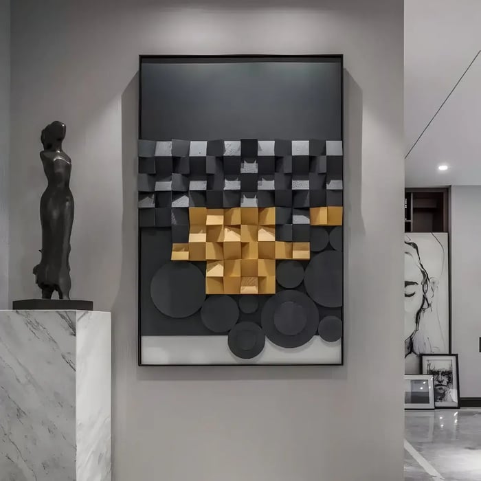 A sophisticated space featuring a framed wall sculpture composed of black and gold cubes and circular elements, creating a bold architectural statement.