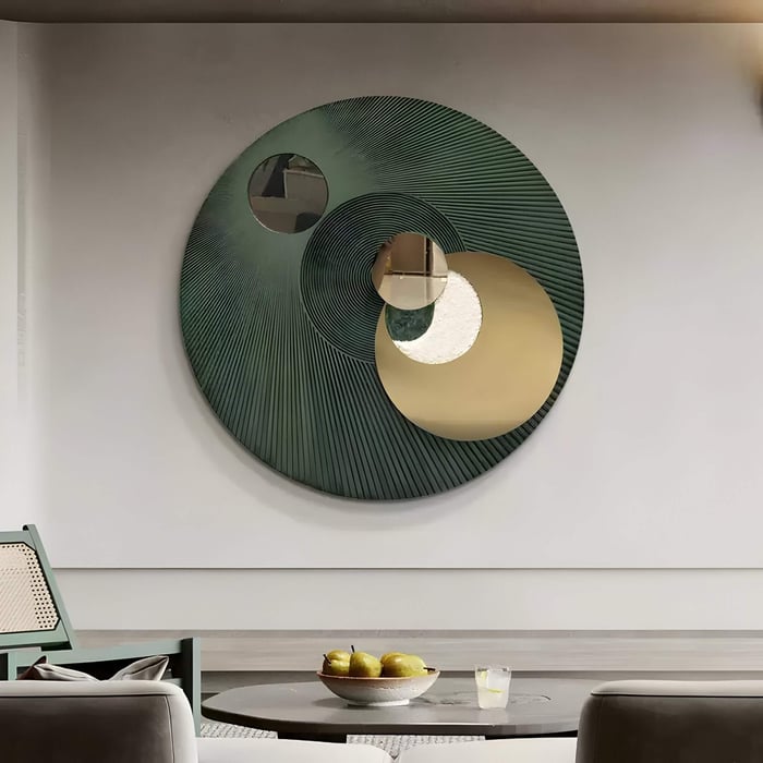 Dining area with oversized circular wall sculpture in green and gold tones, featuring layered concentric mirrored details.